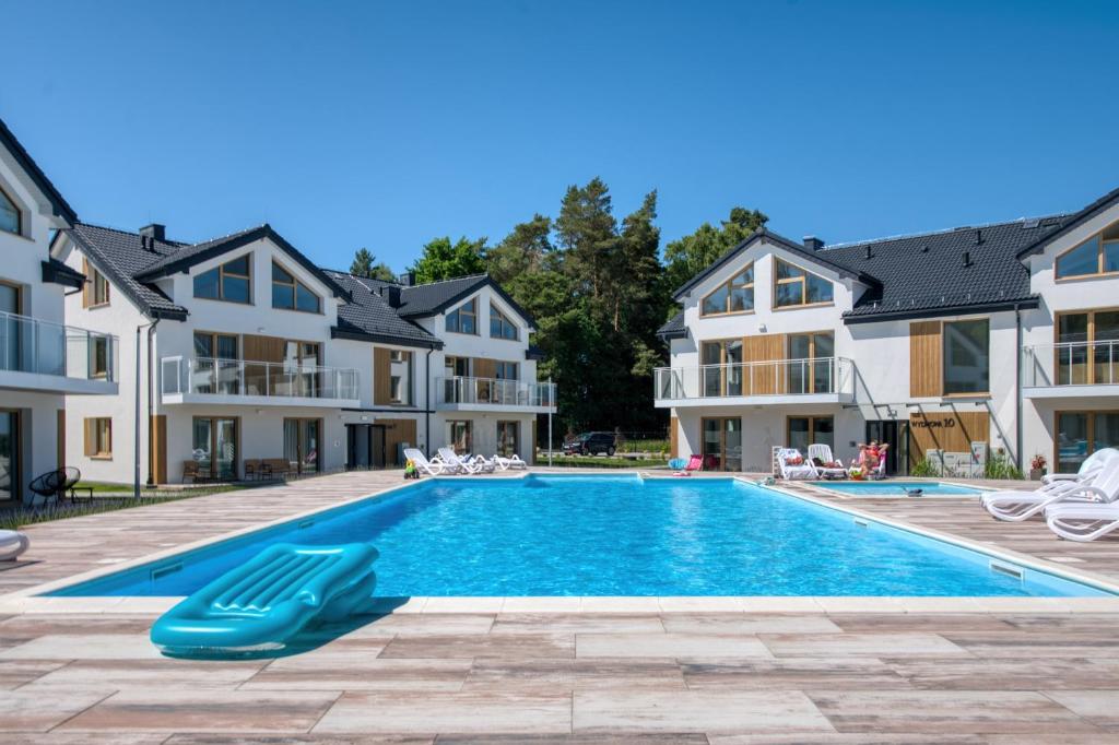 a swimming pool in the middle of a house at Łebska Osada- basen, parking in Żarnowska
