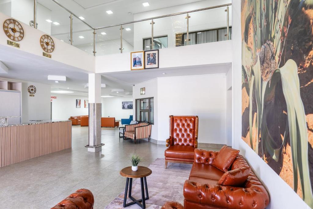 a living room with a couch and a table at Emirates Hotel in Ondangwa