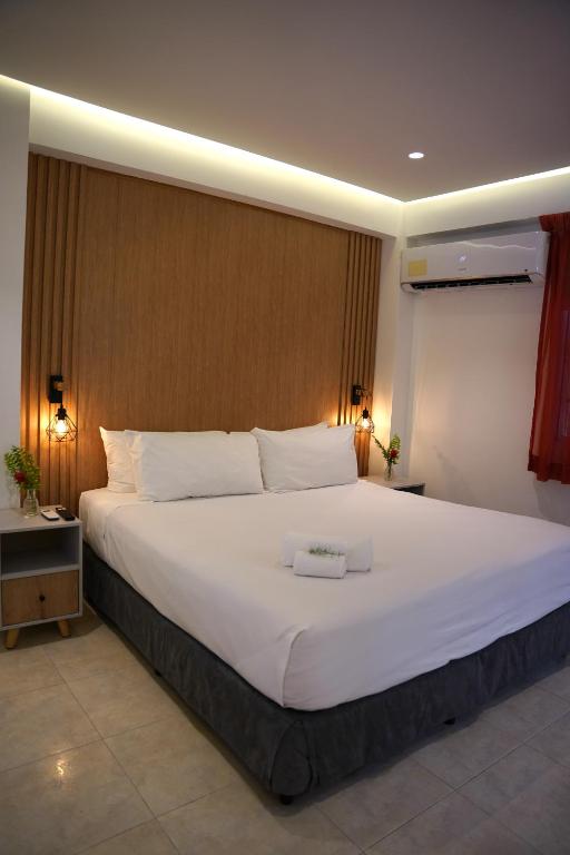 a large white bed in a hotel room at Albrook Inn in Panama City