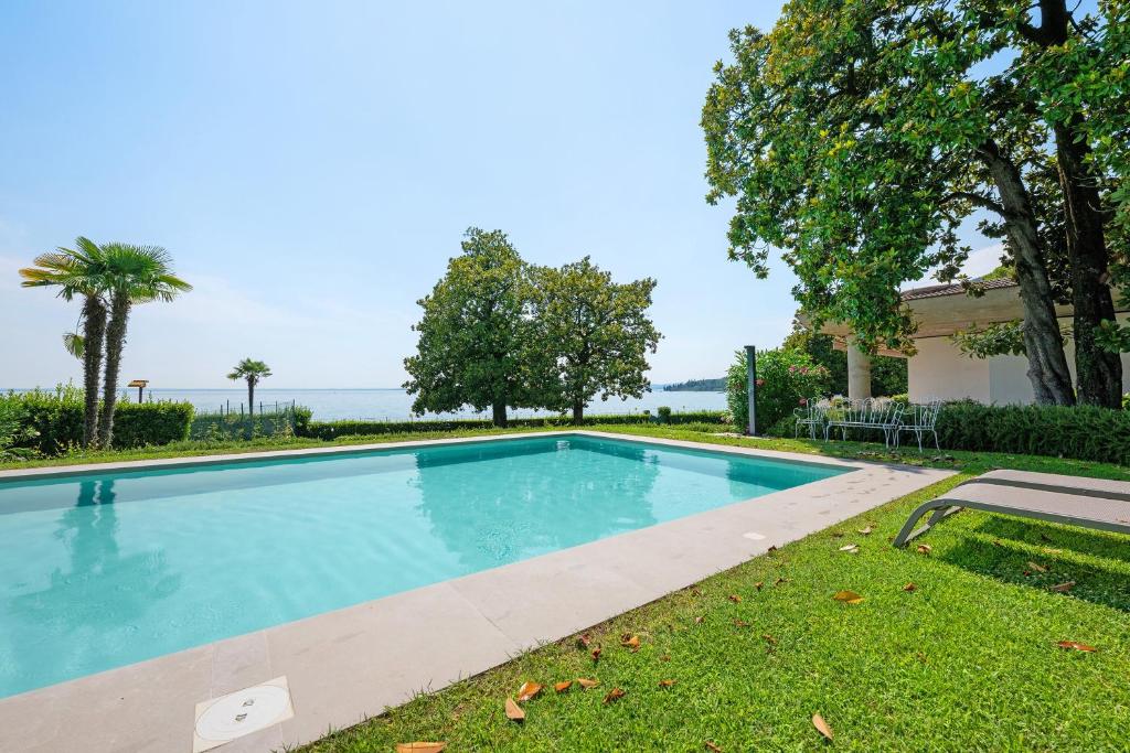 a swimming pool in the yard of a house at Appartamenti Villa Andrea in Garda