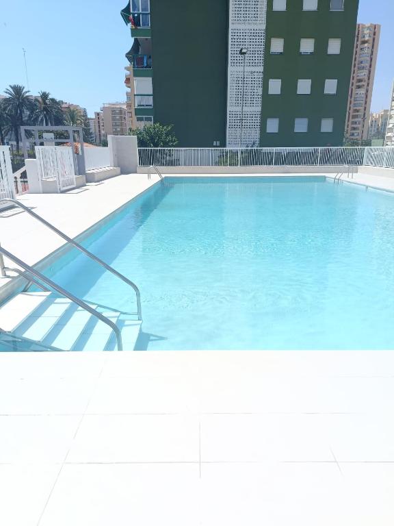 a large swimming pool on top of a building at Fleming's Beach in Puebla de Farnals
