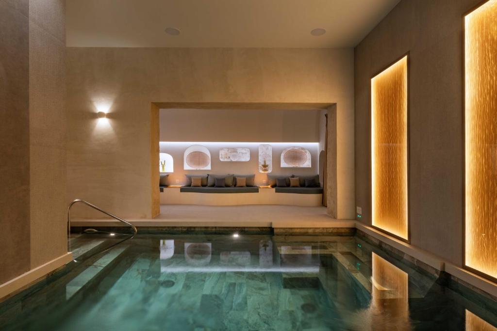 a swimming pool in the middle of a room at Résidence & Spa Le Prince Régent in Paris