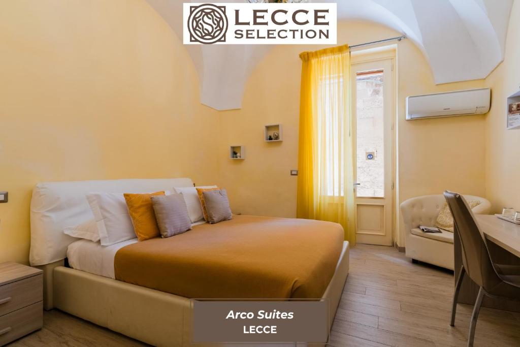 a bed in a room with a desk and a bed sidx sidx sidx at Arco Suite - Lecce Selection in Lecce