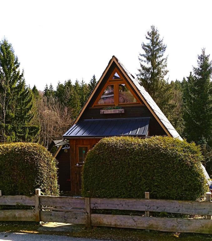a small house with a fence in front of it at Charmantes Ferienhaus mit Garten in Siegsdorf