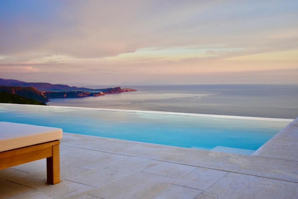 a swimming pool with a view of the ocean at Apiron Luxury Villa in Agía Kyriakí