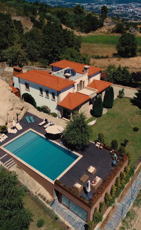 an aerial view of a house with a swimming pool at Royal Fraga do Douro in Vila Real