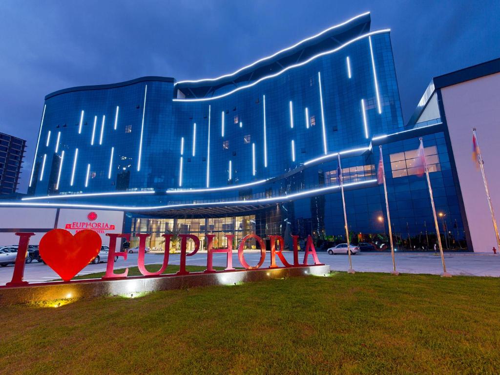 a building with a heart sign in front of it at Euphoria Batumi Convention & Casino Hotel in Batumi