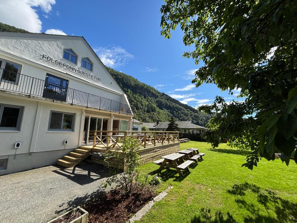 a building with a picnic table in the grass at Folgefonn Gjestetun in Jondal