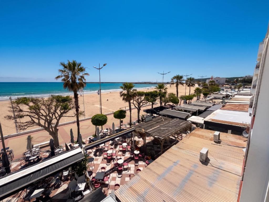 a view of the beach from the balcony of a resort at Spacious Apartment in Barbate - Terrace with Sea View in Barbate