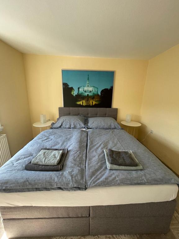 a bedroom with a bed with two pillows on it at Alte Wollspinnerei Melsungen in Melsungen