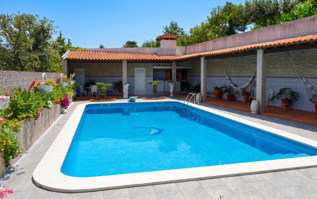a swimming pool in front of a house at Spacious Villa with Private Pool in Oliveira de Azeméis in Oliveira de Azemeis