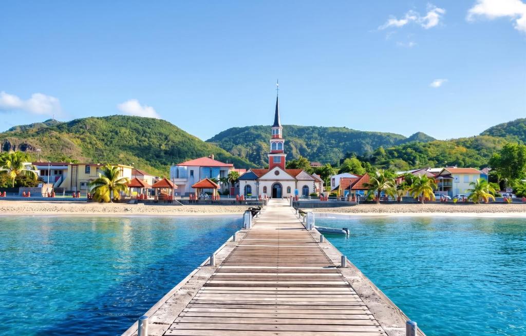 a bridge over a body of water with a church at Appartement confortable à Sainte-Luce avec jacuzzi in Sainte-Luce
