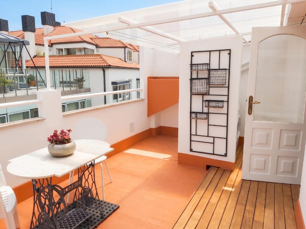 a balcony with a table and a white door at Spacious house with terrace and balcony in A Coruña in A Coruña