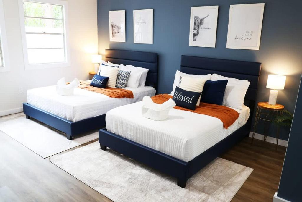 two beds in a room with blue walls at Charming Oasis - Ultimate Rustic Getaway! in St. Augustine