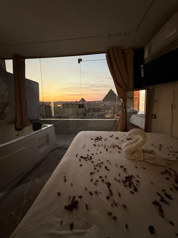 a bedroom with a messy bed with a view of a city at Middle east panorama jacuzzi & spa in Cairo