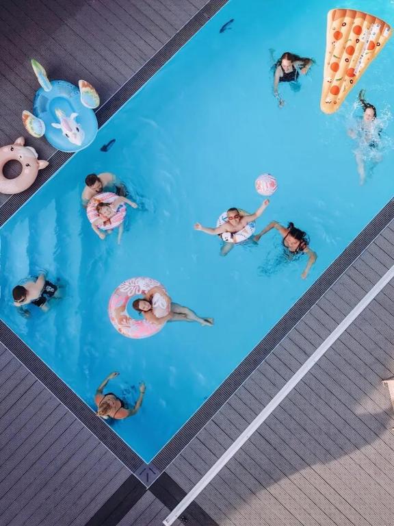 an overhead view of people in a swimming pool at Atpūtas komplekss "Seaside Apartments Roja" in Roja