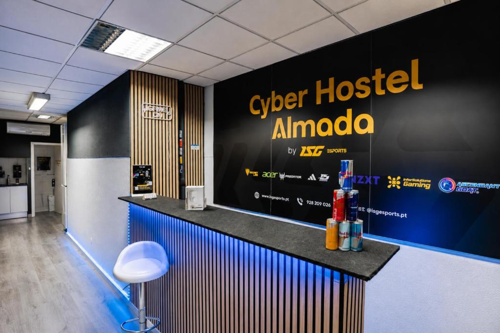 a bar in an office with a sign on the wall at CyberHostel Almada in Almada