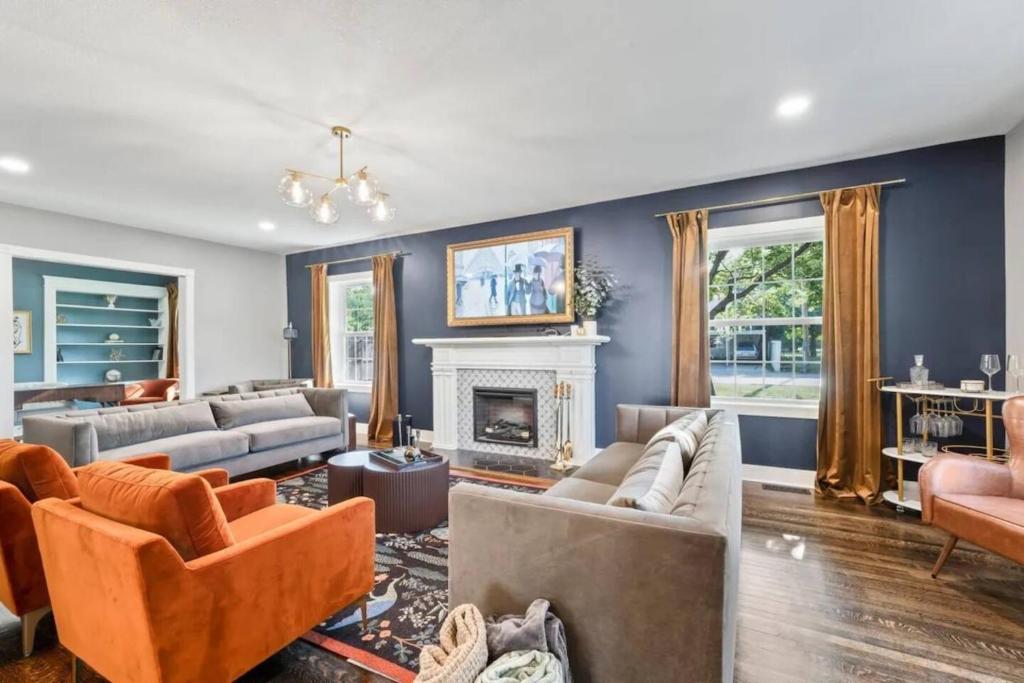 a living room with couches and a fireplace at The Legacy House in Topeka