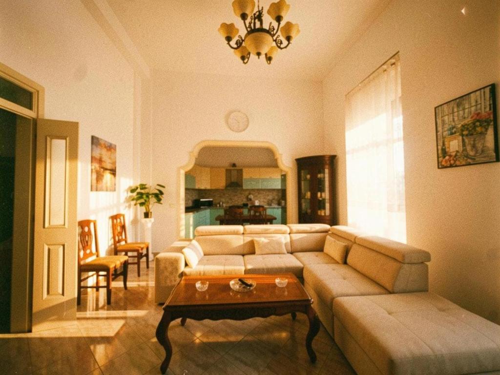 a living room with a couch and a table at Star Apartment 2- Spacious in the heart of Durres in Durrës
