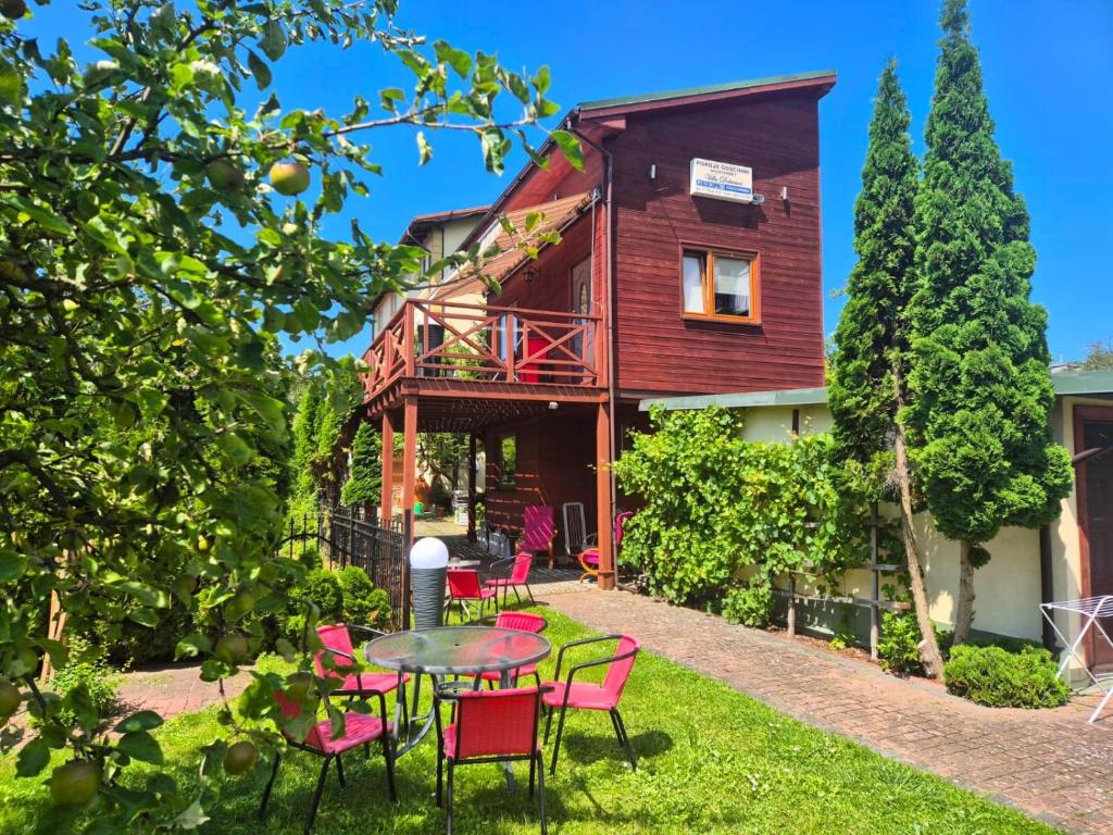 a house with a table and chairs in the yard at Domek Dobrawa- 400m do morza in Międzyzdroje