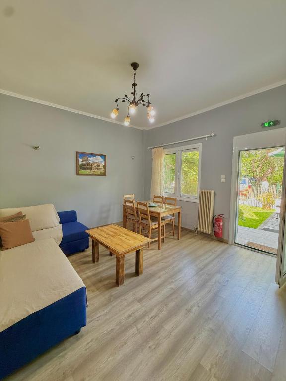 a bedroom with a bed and a table and a dining room at Captain Michalis house in Parga