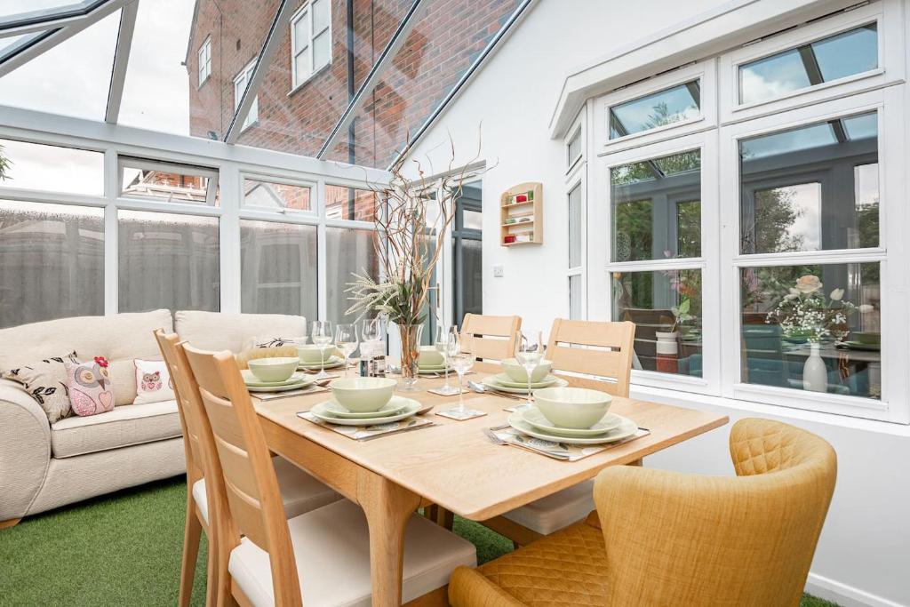 a dining room with a wooden table and chairs at 4 Bedroom Town House with Parking in Shrewsbury