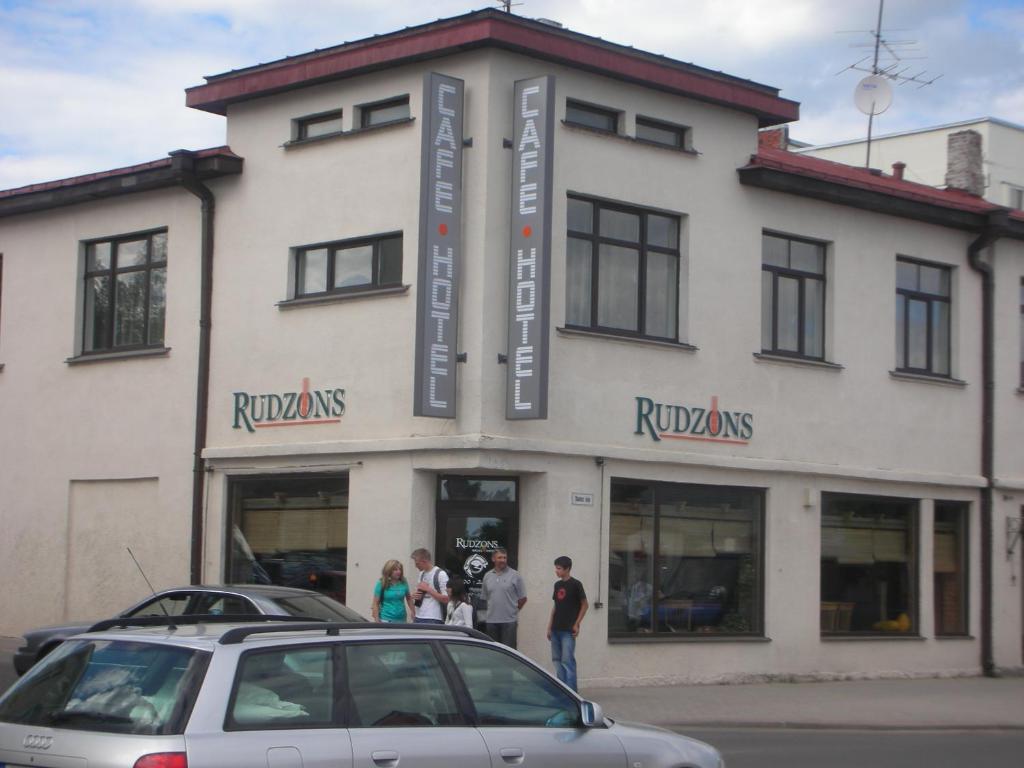 a car parked in front of a building at Cafe Hotel Rudzons in Madona