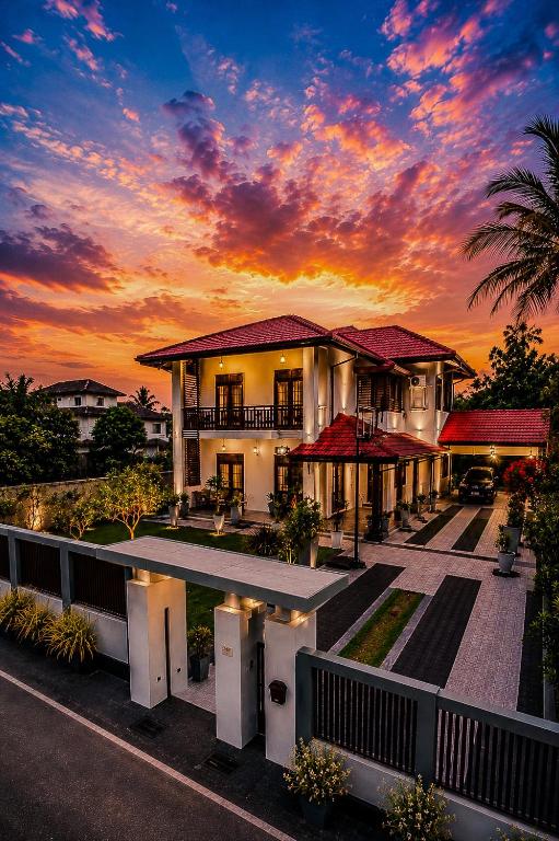 a house with a sunset in the background at Sella Villa-Transit Airport in Seeduwa