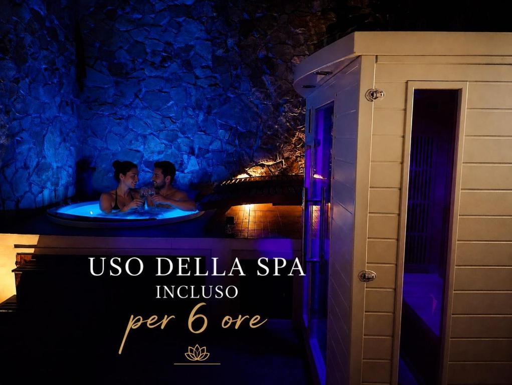 a man and woman in a bathtub at a resort at SPA SUITE SICILIA - Suite con Spa privata ad uso esclusivo Jacuzzi Sauna Hammam in Rosolini