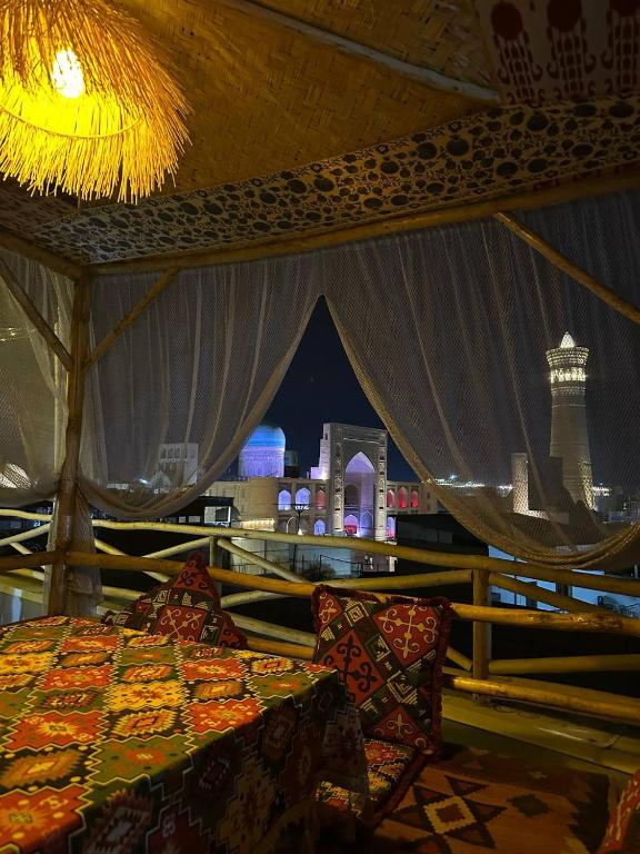 a tent with a bed and a view of a city at LAYALI Boutique in Bukhara