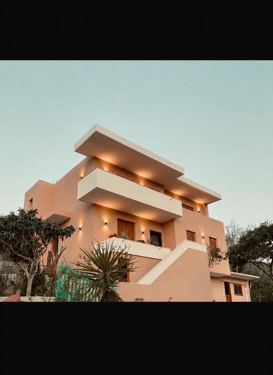 a building with lights on the side of it at APARTAMENT RADHIME in Vlorë