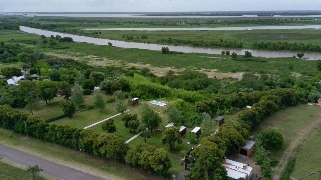 an aerial view of a farm with a river at Destinar Tiny House in San Pedro