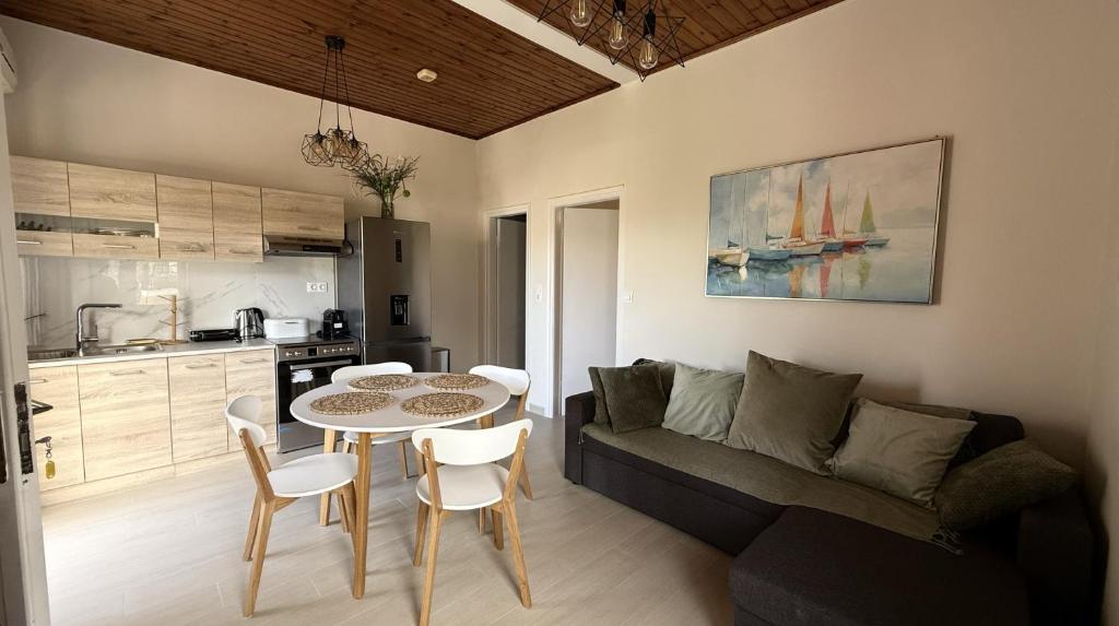 a living room with a table and a couch at Ria's Garden House in Kassiopi