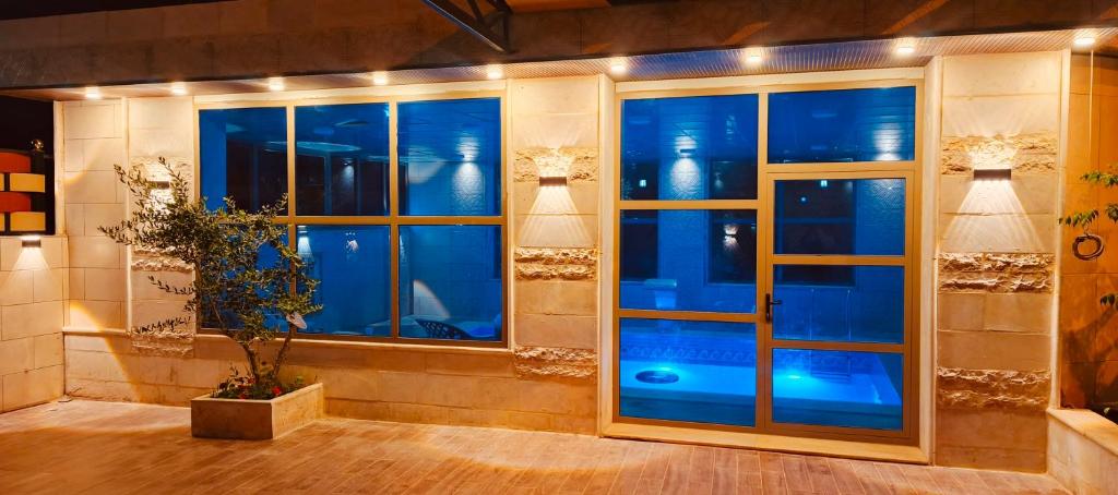 a room with a window with blue lights at Top "OverView" Resort اطلالة القمة in Al ‘Āmirīyah