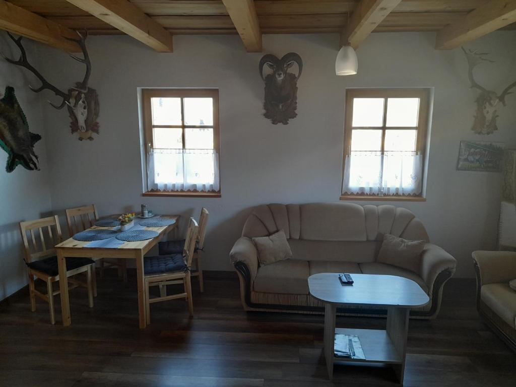 a living room with a couch and a table at Chata pod Urbanovym Vrchom in Čierny Blh