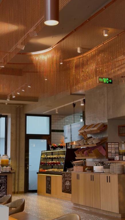 a fast food restaurant with a counter with food at Stay-Inn Bielefeld Zentrum in Bielefeld