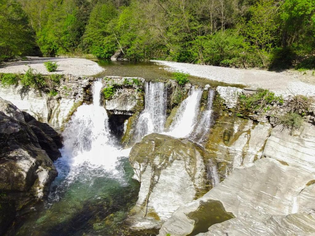 a waterfall in the middle of a river at Le Souffle des Cévennes in Saint-Étienne-Vallée-Française