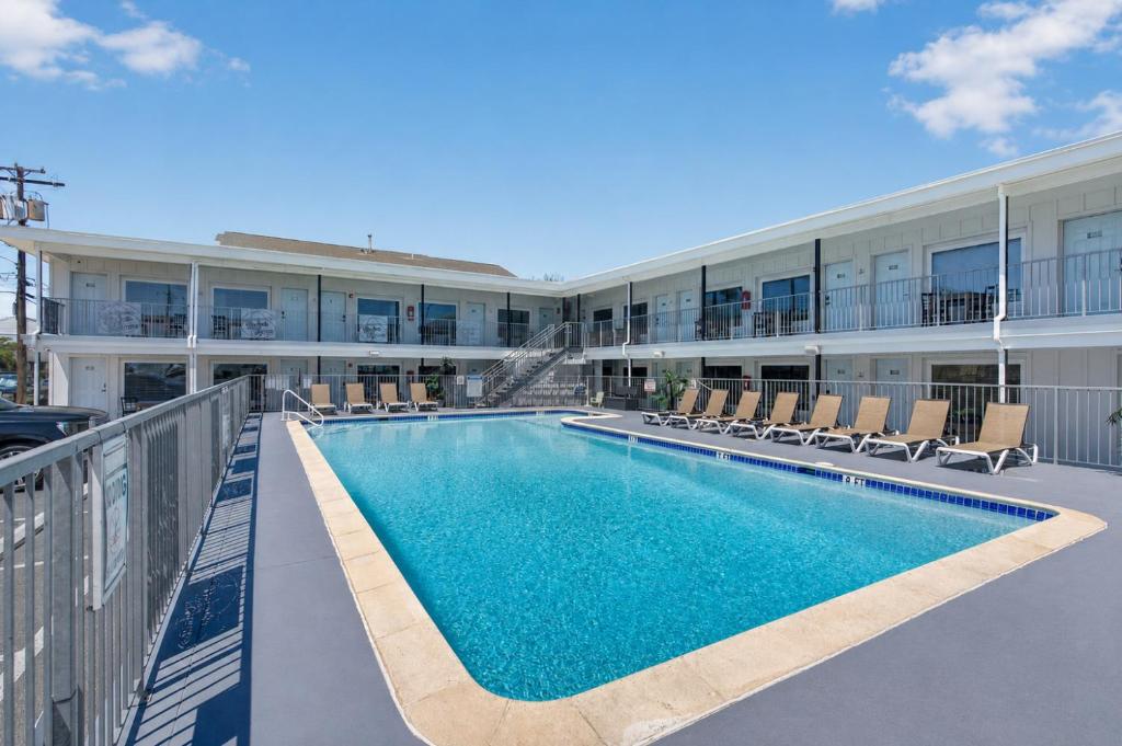 a swimming pool in front of a building at The Beach House in Wildwood