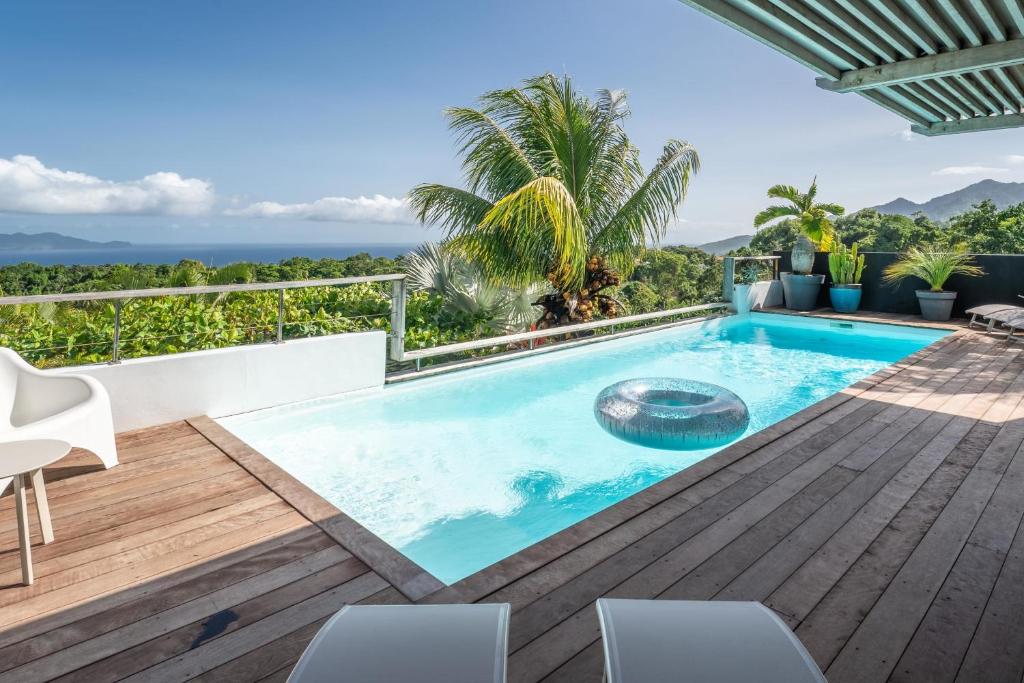 a swimming pool on the deck of a villa at Villa Bananes Rouges in Boyer