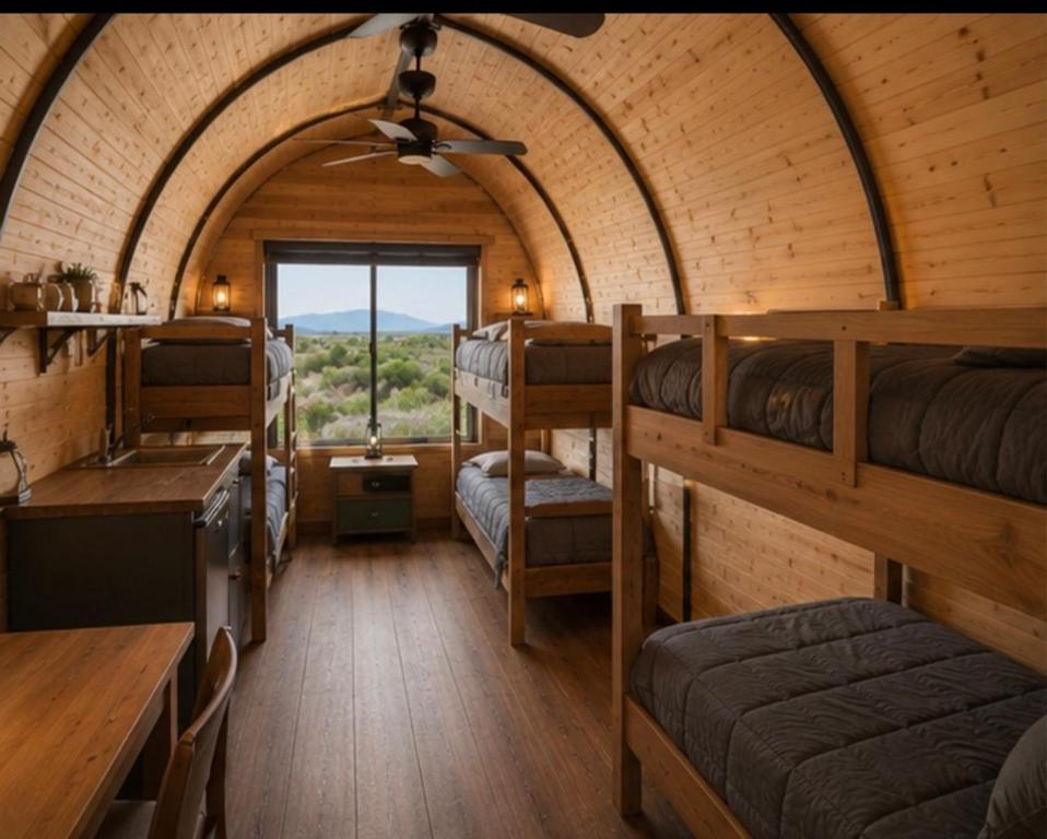 a small room with bunk beds in a train at Sauron Adventure Bungaloft in Villa Carlos Paz
