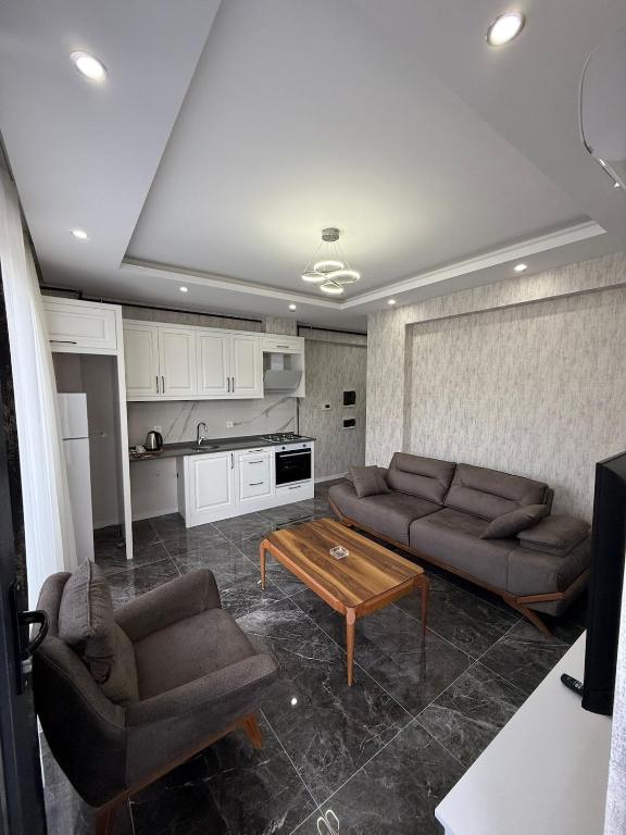 a living room with two couches and a table at Denizli - Akcakoca Suite in Zeytinkoy