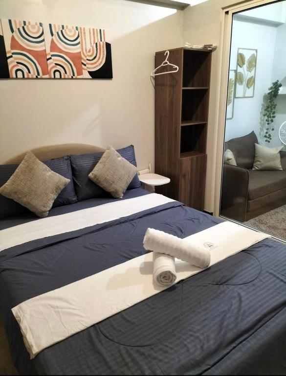 a bedroom with a bed with towels on it at Condominium luxury with balcon ocean breeze in Davao City