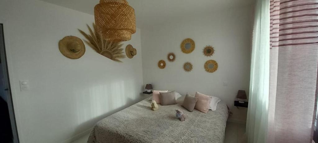 a bedroom with a bed with pillows on it at Chambres D'Hotes Chez Sylvie in Cancale