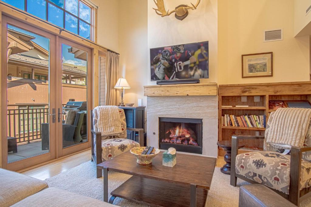 a living room with a fireplace and a table at Elkhorn View Retreat in Sun Valley