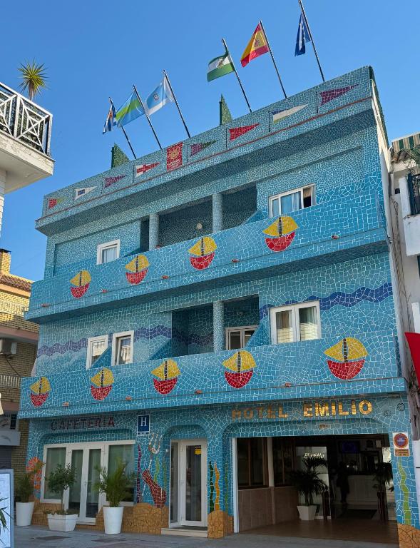 ein blaues Gebäude mit Früchten an der Fassade in der Unterkunft Hotel Emilio in Punta Umbría