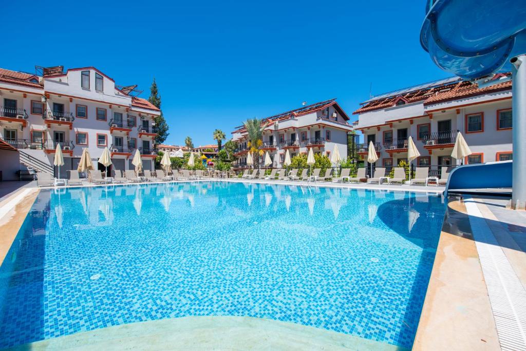 a swimming pool in the middle of a building at Casa De Levıssı Ölüdeniz in Oludeniz