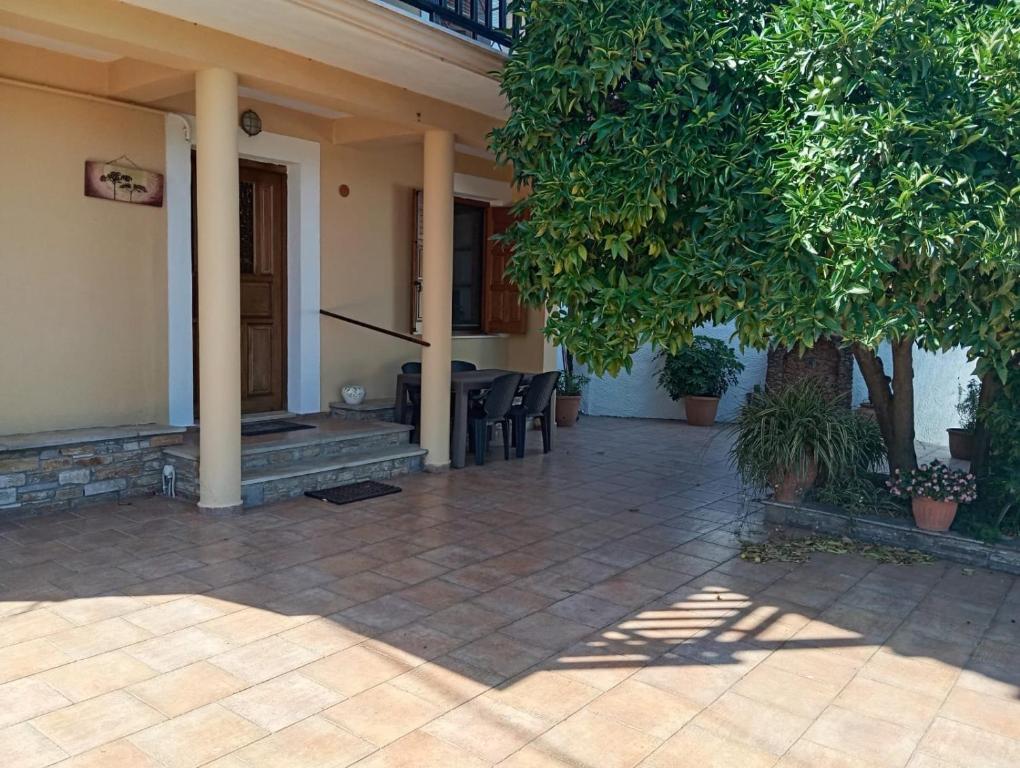 a porch of a house with chairs and trees at Deli House in Promírion