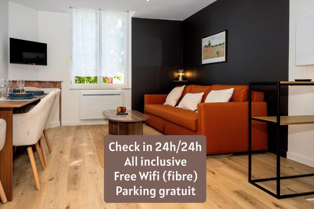 a living room with a couch and a table at La Suite Cacao in Saint-Rambert-dʼAlbon