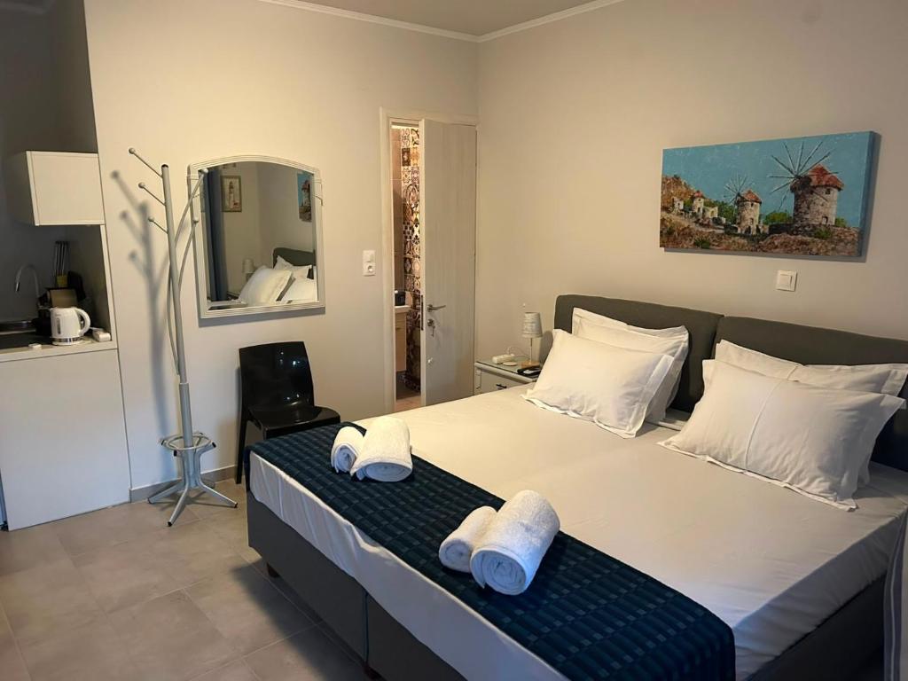 a bedroom with a large bed with towels on it at Lemnos Nest in Kondiás