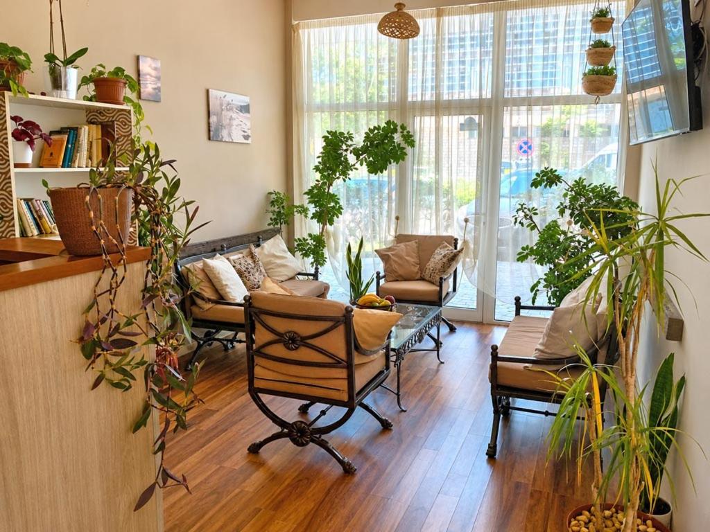 a living room filled with lots of plants at Liora studio apartments in Sunny Beach